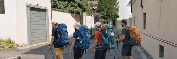 Gruppo di pellegrini in cammino a Brescia lungo la bretella urbana del Cammino di Santa Giulia, nei pressi di Via della Rocca